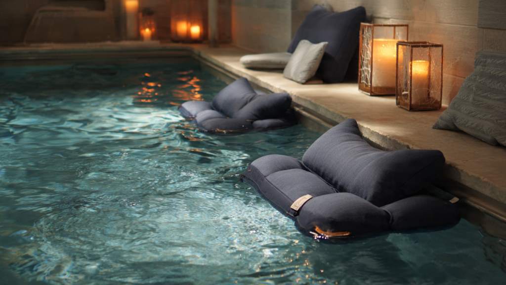 Cozy spa setup featuring a luxurious waterproof bath pillow cradling a relaxing bather in a steaming tub