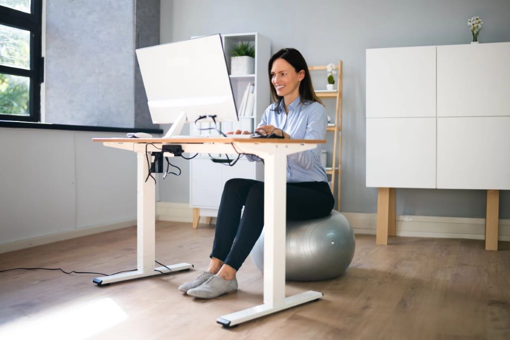 Standing desk and sitting desk comparison in a modern office workspace